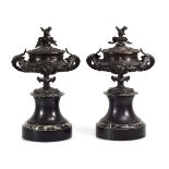 A pair of late 19th century bronze urns and covers on marble columns, h. 36 cm each (2)