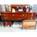 A George III mahogany, crossbanded and ebony strung bow-fronted sideboard with an arrangement of six