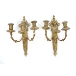 A pair of brass three-branch wall sconces, h. 35 cm