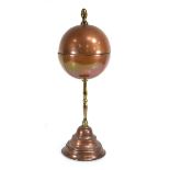 A 19th century copper, brass and tole (?)puzzle ball on stand, h. 45 cm