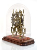 A brass skeleton clock or timepiece with a fusee movement, modelled as a cathedral, the silvered