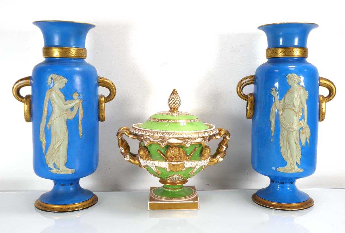 A pair of late 19th century vases of classical form, each with ring handles and decorated with a