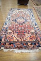An Afghan carpet with a red and blue ground, matching bands, 296 x 151 cm Discolouration in places.