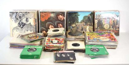 A large group of Beatles LPs, 12" and singles including 'Sgt Pepper's Lonely Hearts Club Band', '