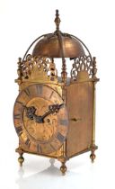 A lantern clock with a double fusee movement striking on a bell, the dial signed 'Dollond London',