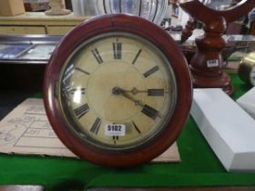 A late 19th/early 20th century wall clock striking on a bell, with a painted face and beech circular