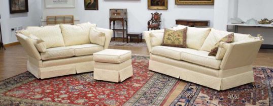 A pair of Peter Guild knole drop-end sofas upholstered in cream together with a matching footstool