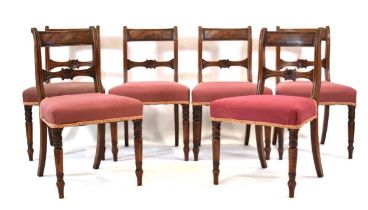 A set of six George III mahogany bar-back dining chairs with upholstered seats, on turned front