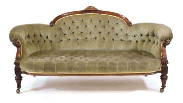 A late Victorian walnut and button upholstered parlour sofa on turned legs with later castors, w.