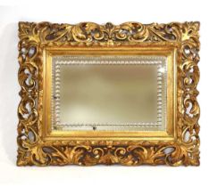 A 19th century giltwood fretwork wall mirror, the rectangular plate with etched decorated and