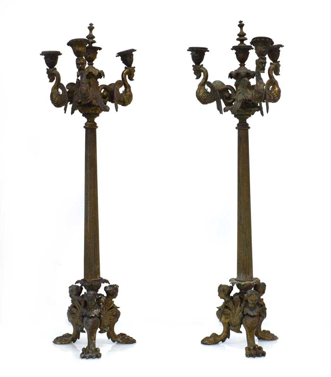 A pair of late 19th century French cast metal and gilded candelabrum with figural masks and claw