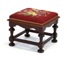 An early 20th century mahogany and embroidered stool with a label with 'R. James, Cabinetmaker...