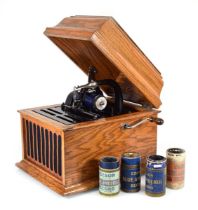 An Edison oak cased phonograph together with four cased and one loose roll, the case itself