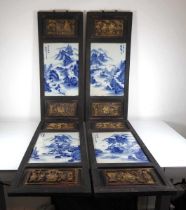 A set of four Chinese Export blue and white porcelain plaques, each depicting a mountainous scene in