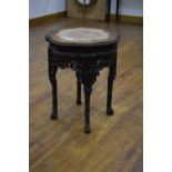 A 19th century Chinese Export hardwood table inset with a rouge marble surface over a shaped apron