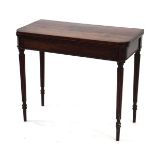 An early 19th century mahogany card table, the folding surface over a plain frieze, on reeded