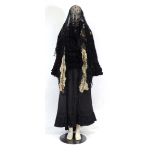 A Victorian mourning outfit including a black shawl, matching skirt, veil, muffler and lace collar