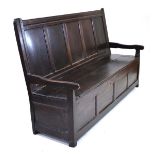 An 18th century oak settle or bench with a five panelled back over a lift seat, w. 193 cm h. 115 cm,