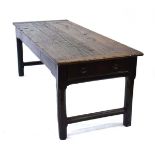 An 18th century and later oak plank-top refectory or kitchen table with a single frieze drawer on