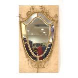 A 19th century wall mirror, the bevelled glass panels within a giltwood and plaster frame of