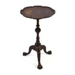 A 19th century mahogany wine table, the pie-crust surface on a turned column and tripod base with