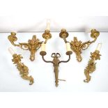 A pair of gilt two-branch wall sconces with putti masks, electrified, together with three further
