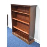 An Edwardian mahogany open bookcase with three adjustable shelves on a plinth base, w. 104 x h.