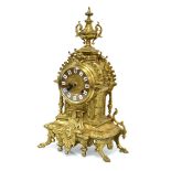 A reproduction mantle clock, the German movement striking on a bell, within a brass case of