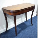 An early 19th century mahogany tea table, the fold-over surface above an ebony line strung frieze