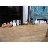 +VAT Quantity of white and terracotta jugs and planters (under 2 cabinets)