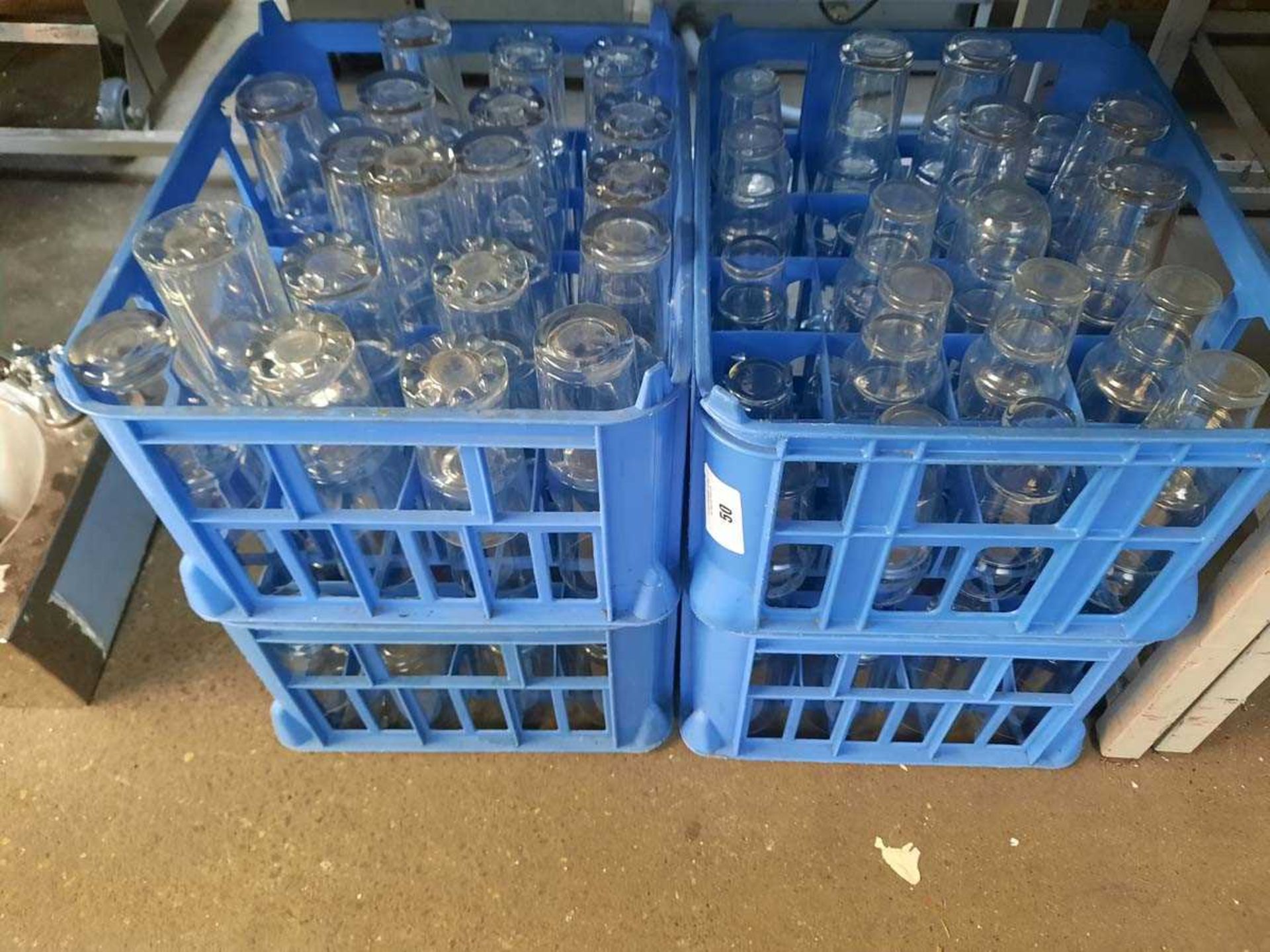 +VAT 4 blue plastic stacking crates containing assorted glass tumblers