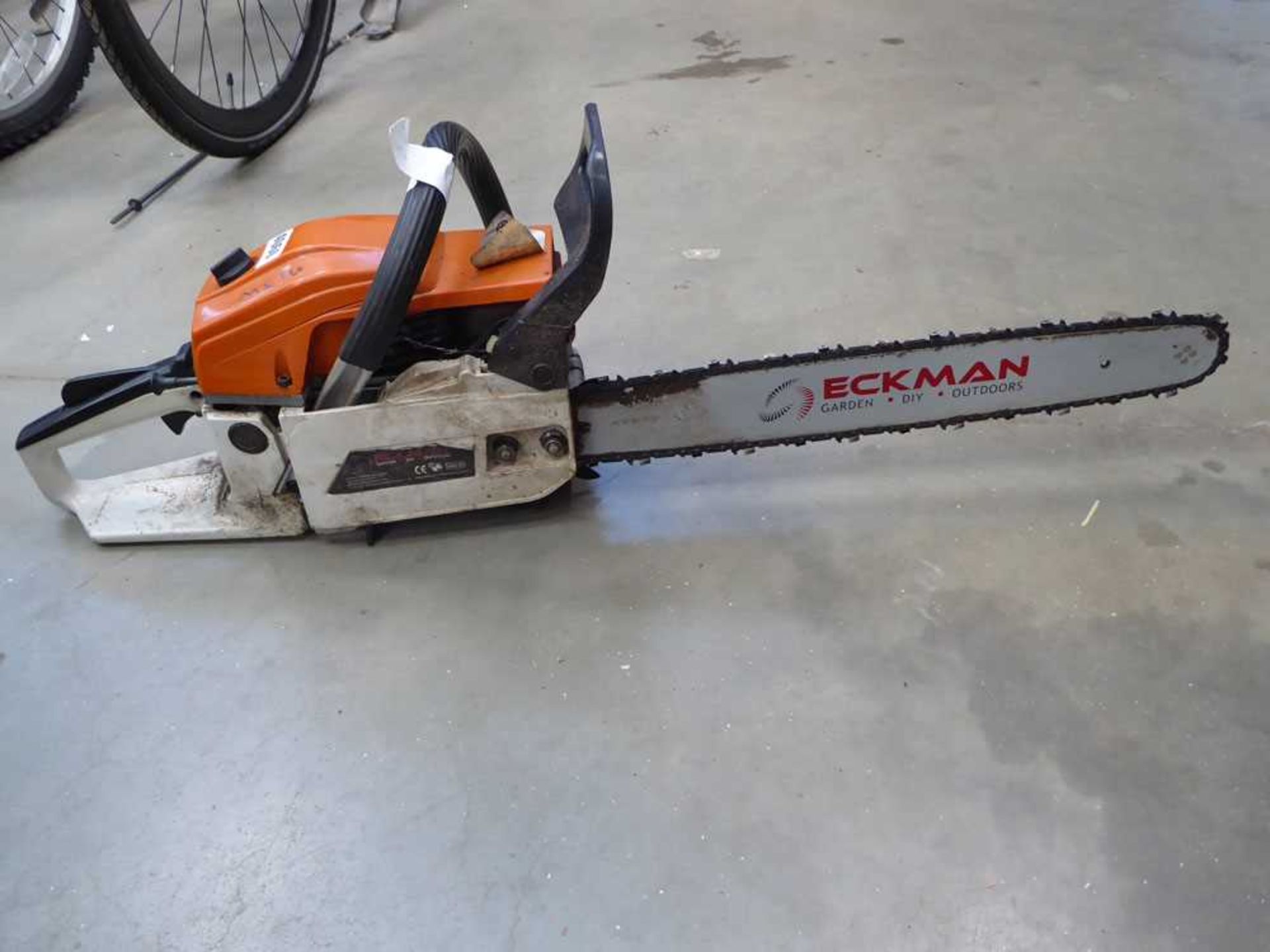 Orange and white petrol powered chainsaw