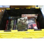 Box containing reference books and novels