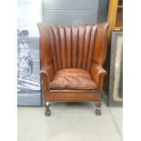 Leather porters chair with carved frame