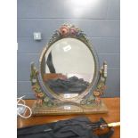 A toilet mirror with floral supports