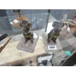 Pair of metal ornamental dogs on marble plinths