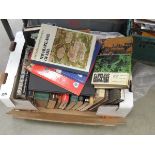 Box containing reference books and novels