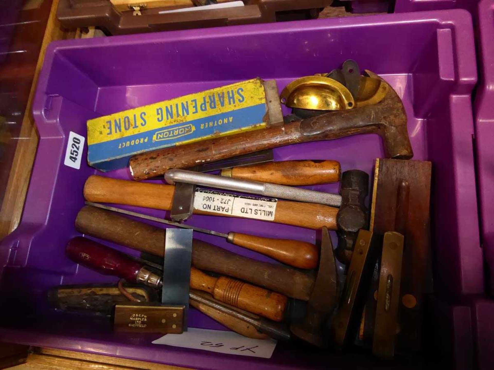 Purple box containing small spirit levels, hammers and files