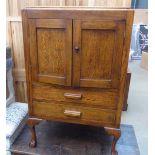 An oak sewing or collectors cabinet