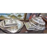 A group of silver plated wares including serving trays, bacon dishes and meat covers (7)