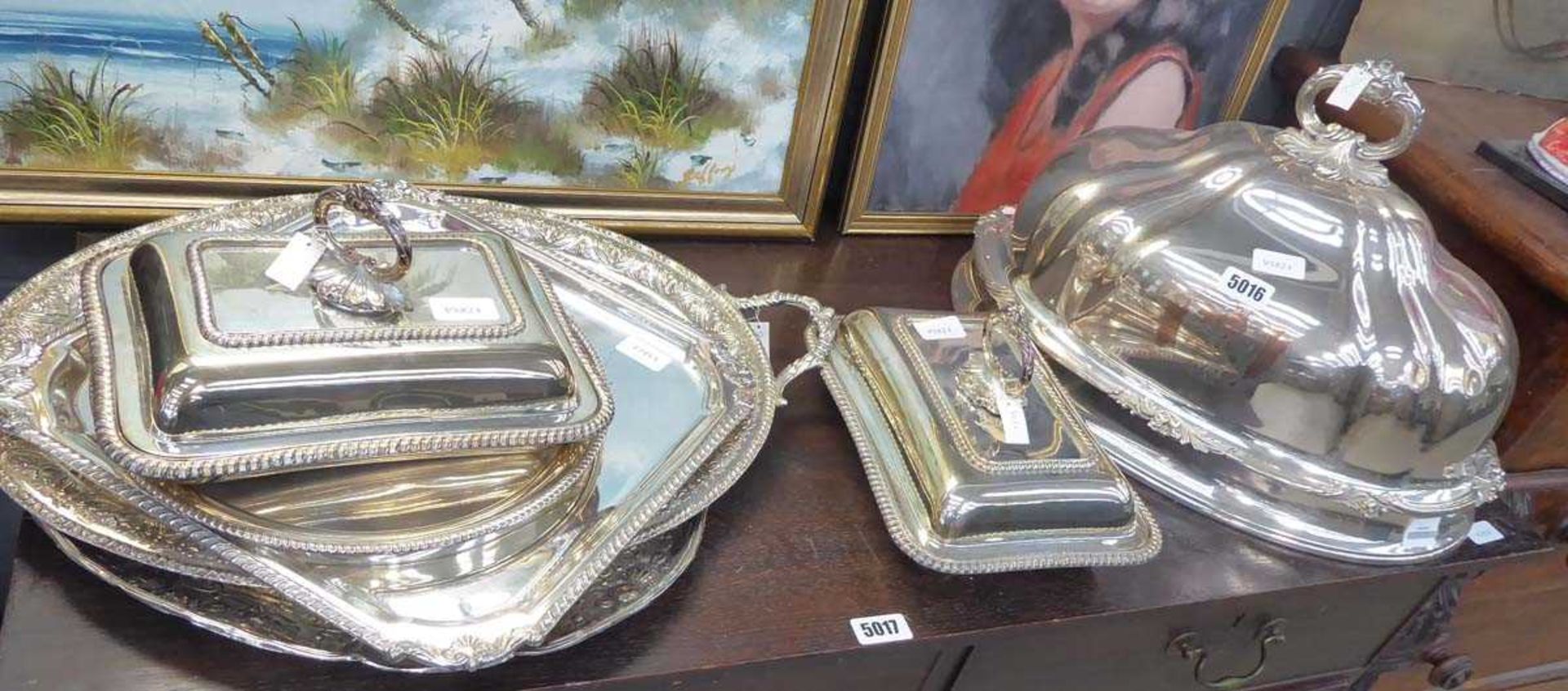 A group of silver plated wares including serving trays, bacon dishes and meat covers (7)