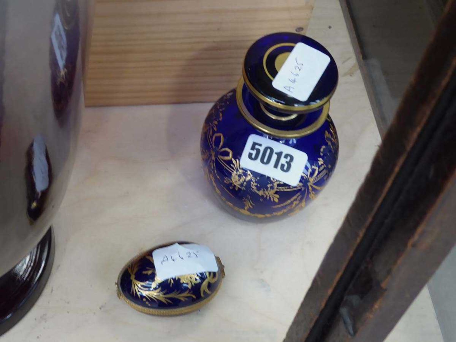 Blue and gilt glass scent bottle and an egg shaped lamoges pill box