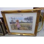 A 20th century framed and glazed lithographic print depicting a child in an orchard