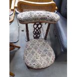 Heavily carved nursing chair in floral upholstery