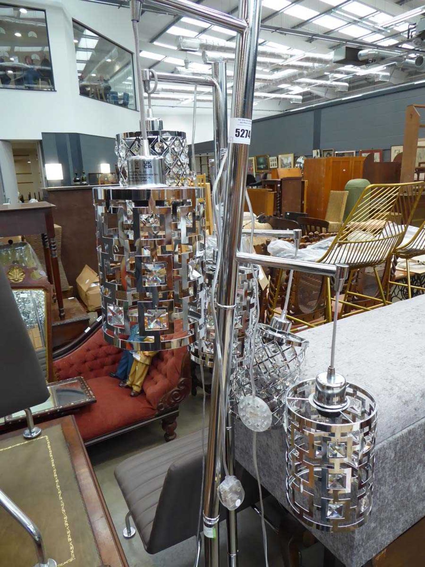 +VAT A pair of chromed three branched floor lamps, as found