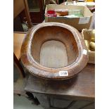 A 'distressed' stained beech oval bowl bound with brass straps