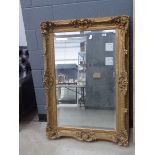 A large 19th century style rectangular bevelled mirror in a decorative gilt frame