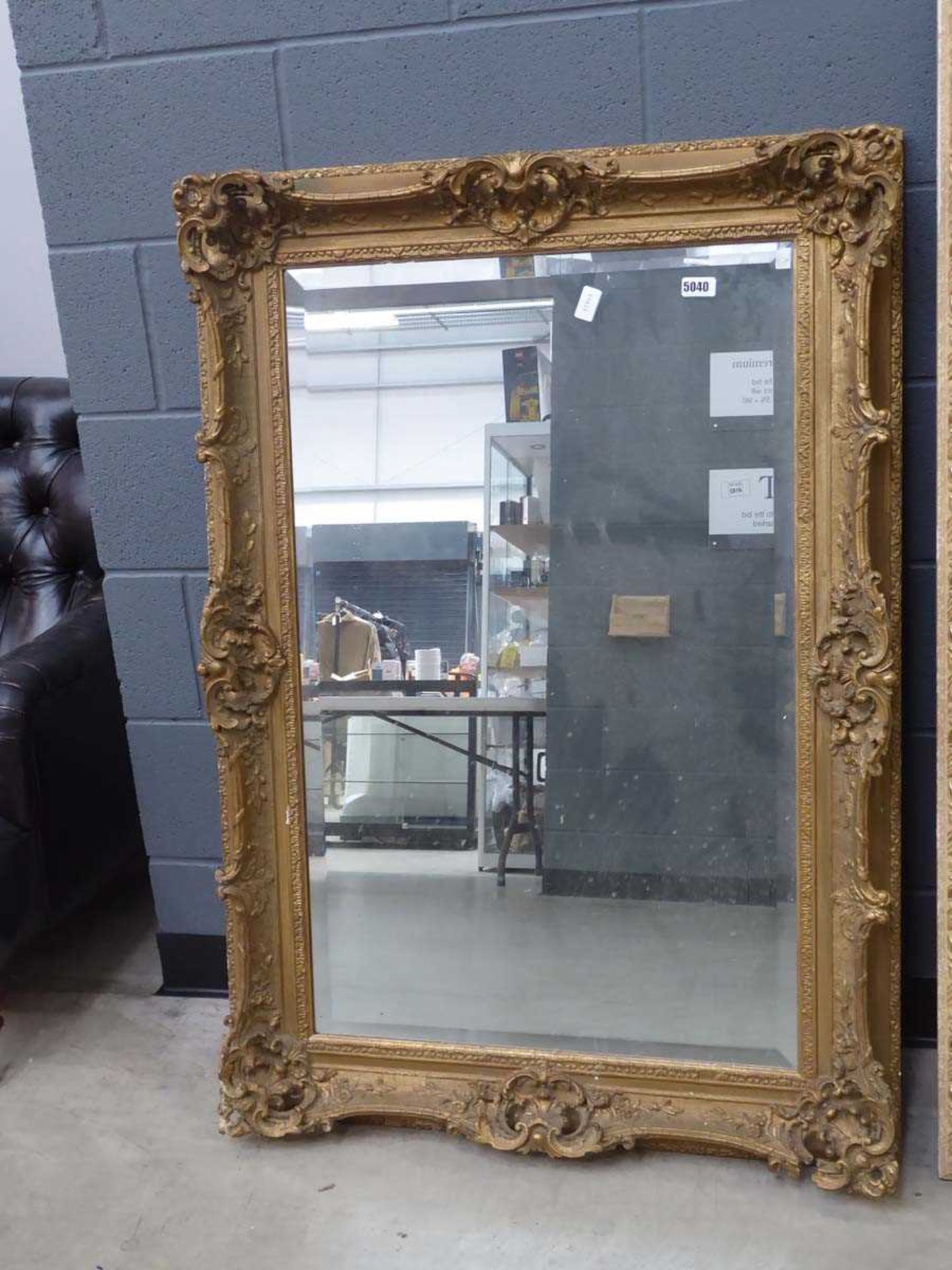 A large 19th century style rectangular bevelled mirror in a decorative gilt frame