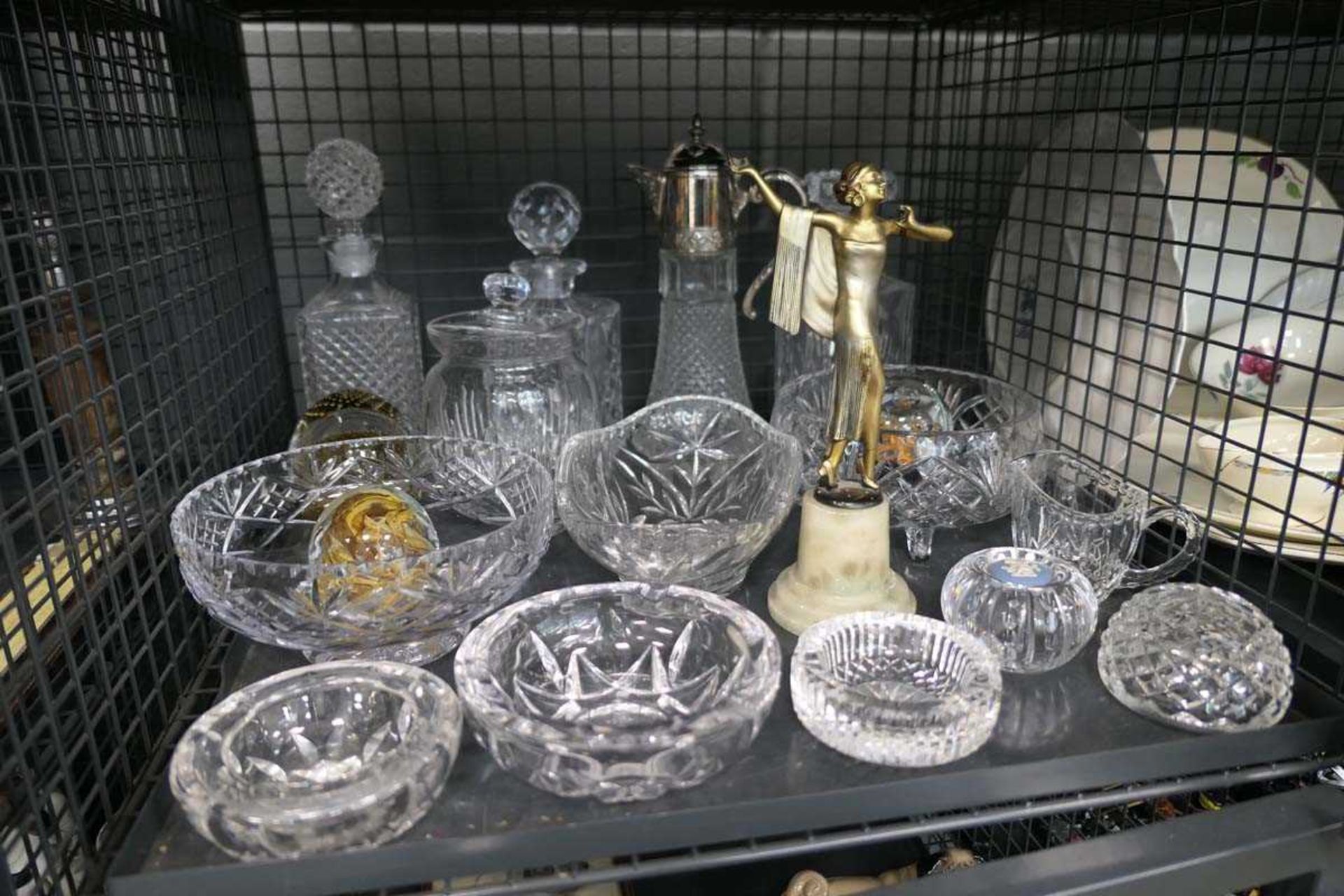 Cage containing a claret jug, decanters, biscuit barrel, paperweights, art deco style figure, jug