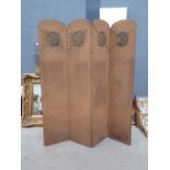 A vintage four-panel fabric screen or room divider